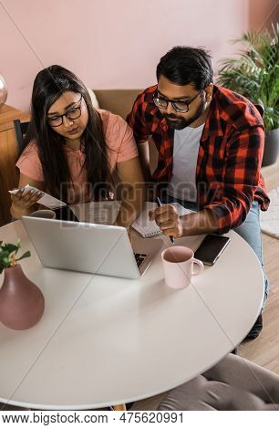 Serious Wife And Husband Planning Budget, Checking Finances, Focused Young Woman Using Online Calcul