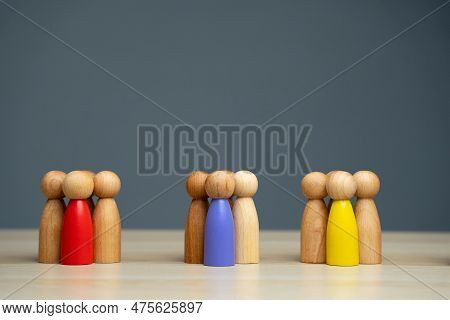 Groups Of Multicolored Wooden People On A Gray Background. The Concept Of Market Segmentation. Targe