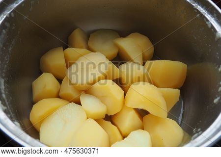 Boiled Lumpy Potatoes In A Metal Pan, Top View. Boiled Chopped Pieces Of Peeled Potatoes. Cooking Fo