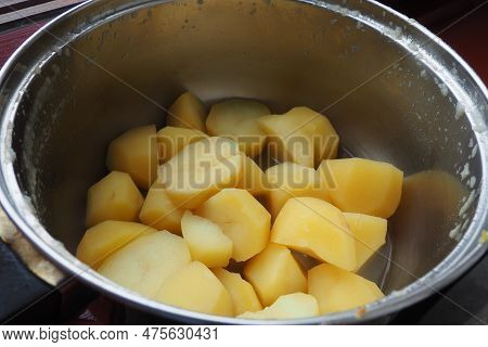 Boiled Lumpy Potatoes In A Metal Pan, Top View. Boiled Chopped Pieces Of Peeled Potatoes. Cooking Fo