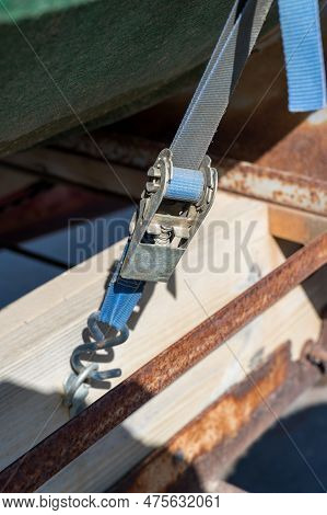 Aged Ratchet Strap In Use And Under Tension In The Outdoors