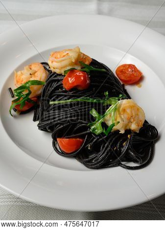 Spaghetti Al Nero Di Seppia Con Gamberi, Italian Pasta With Squid Ink, Prawns, Tomato And Rucola