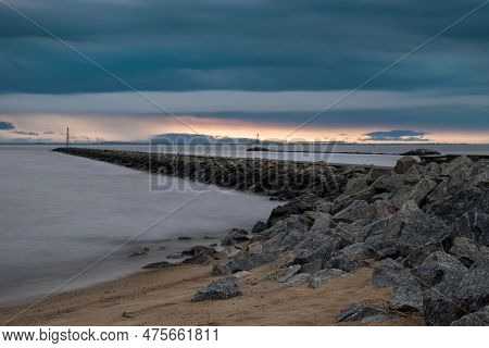 Rocky Pier And Threatening Dark Clouds During Sunset At Playa Sere, Colonia, Uruguay