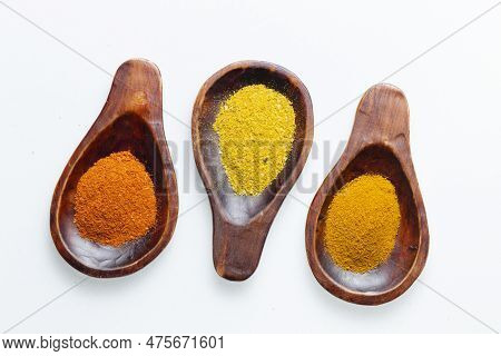 Turmeric, Pepper And Curry Powder In Container On White Background