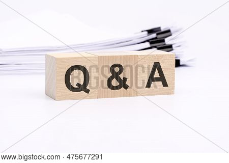 Q And A Letters On Wooden Cubes. The Background Is A White Business Papers. Finance Concept