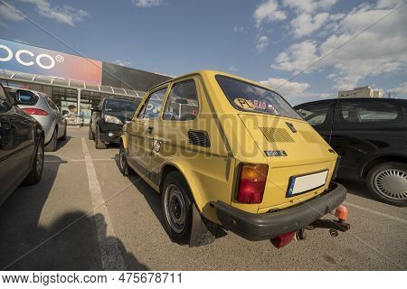 Poland Ostrowiec Swietokrzyski April 20, 2023 At 15:52.  A Small, Yellow Car Made By Polish Fiat 126
