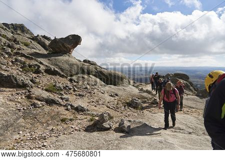 Los Gigantes, Cordoba, Argentina, April 6, 2023: Group Of Hikers Passing Near A Rock Formation Known