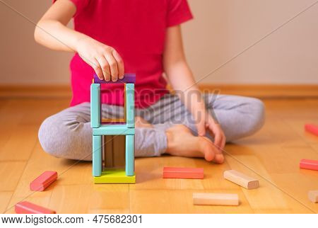 Child Sitting On The Ground In The Flat And Playiing With Colorful Toy Blocks. Educational Game.