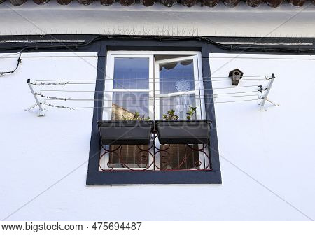Typical Portuguese Facade With Window And Clothesline In Evora Town