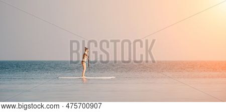 Sea Woman Sup. Silhouette Of Happy Middle Aged Woman In Rainbow Bikini, Surfing On Sup Board, Confid