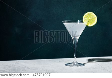 Vodka Gimlet Alcoholic Cocktail With Vodka, Sugar Syrup, Lime Juice And Ice In Martini Glass, Dark G