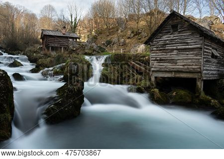 Mountain River With Mossy Rocks And Wooden Watermills In Long Exposure, River Krupa In Krupa Na Vrba