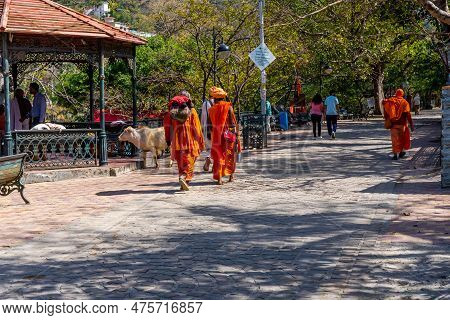 Rishikesh,uttarakhand - 29.03.2023. People In Traditional Orange Siddha Clothes Walk The Streets Of 