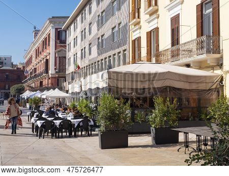 Bari, Italy - October 30, 2021: Garden Restaurant In Bari, Italy With People Drinking Coffee In Fron