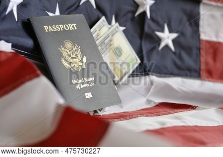 Us Citizen's Passport With Embedded Us Dollar Banknotes On The Us Flag. Identity Document. Close-up.