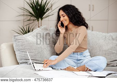 Online Education Concept. Happy Middle Eastern Woman Making Call About Task, Studying At Home With L