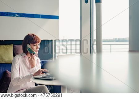 Portrait Of Young Beautiful Businesswoman Doing Work While Sitting In Cafe. The Business World, Many