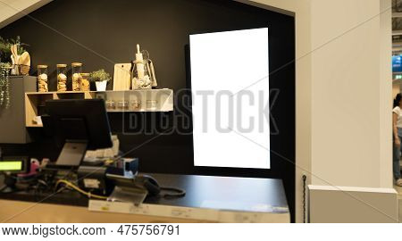 Interior Of A Modern Coffee Bar With A Blank Signboard Behind The Counter And Items On The Shelves. 
