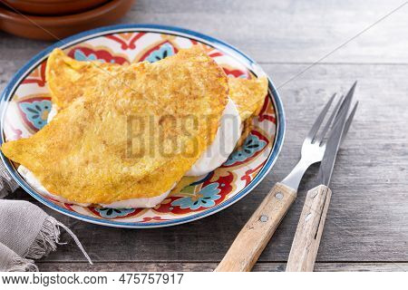 Traditional Venezuelan Beef Cachapa On Wooden Table. Copy Space