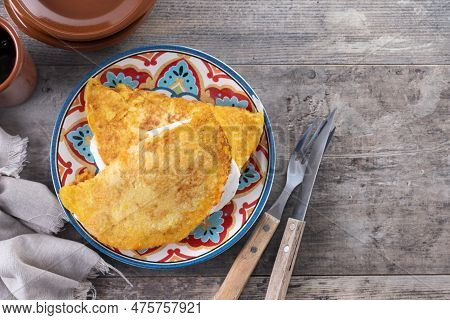 Traditional Venezuelan Beef Cachapa On Wooden Table. Top View. Copy Space