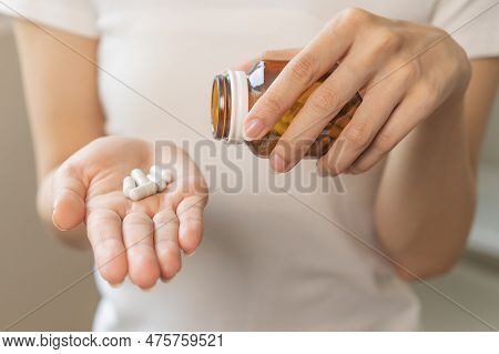 Dietary Supplement Or Sick, Asian Young Woman, Girl Hold Pills, Drugs Medical Tablet On Hand Pouring