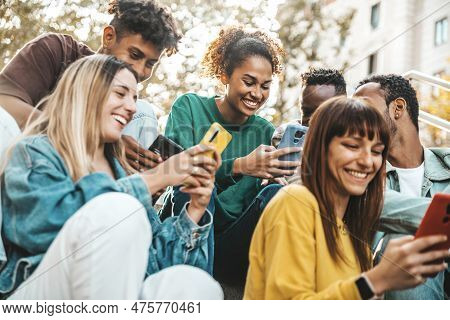 Group Of Multiracial Young People Using Smart Mobile Phone Device Outdoors - Happy University Studen
