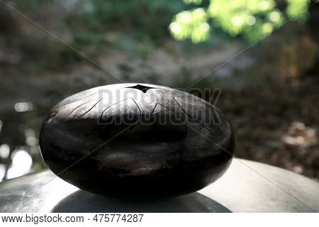 Steel Tongue Drum On Stone Outdoors. Percussion Musical Instrument