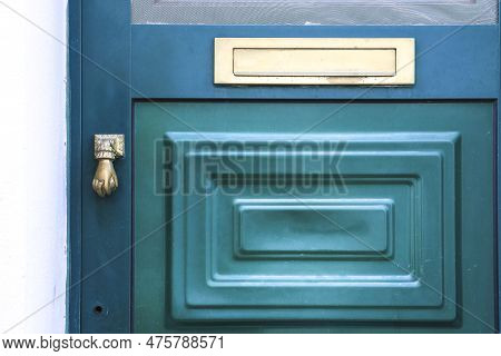 Typical Portuguese Facade With Green Wooden Door On Cobblestone Street In Evora Town, Portugal