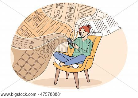 Smiling Millennial Girl Sit Relax In Chair Scroll Social Media Feed On Smartphone. Happy Young Woman