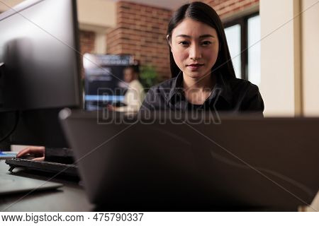 Asian Tech Enginner Analyzing Compiling Html Code On Computer Display, Working On Interface Developm