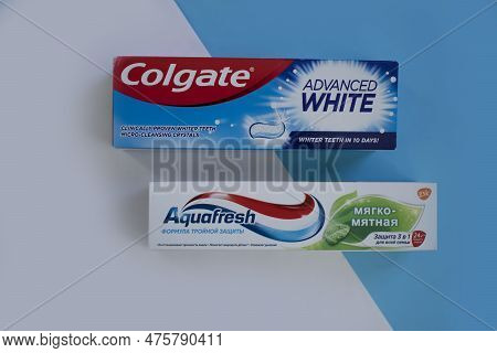 April 25, 2023 Ukraine City Kyiv Toothpaste Colgate And Aquafresh On A Colored Background