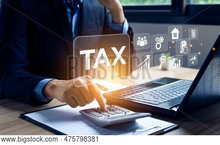 Businessman Calculating Annual Taxes And Paying Taxes. Tax Deduction Planning Concept. Expenses, Acc
