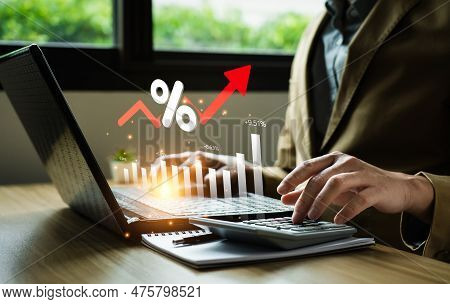 Interest Rates And Dividends, Business People Calculate And Higher Graphs And Percentages Investment