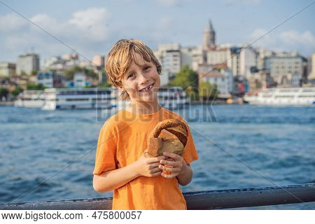 Boy In Istanbul Having Breakfast With Simit And A Glass Of Turkish Tea. Glass Of Turkish Tea And Bag