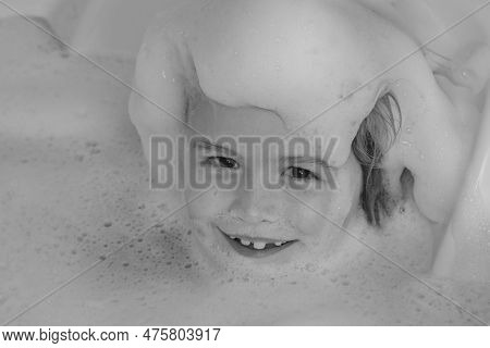 Kids Face In Foam. Kid Having Fun In The Bath With Bubbles. Happy Child Enjoying Bath Time. Little B