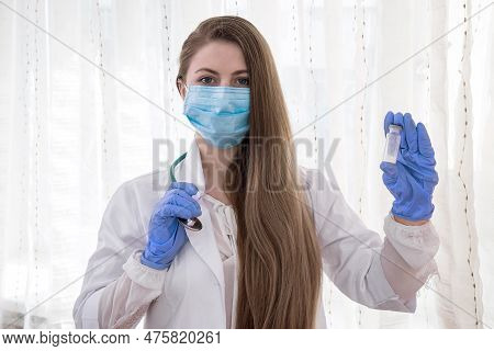Doctor Or Nurse Holding Ampoule With Medicament