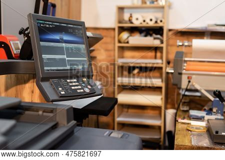 Modern Printer Next To Monitor And Button Panel In Print Center.