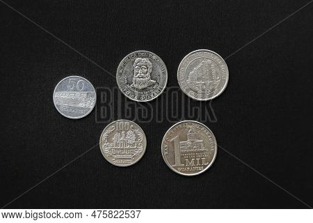 Paraguay Guaranies Coin - Set Of Paraguayan Coins In A Row Isolated On Black Background