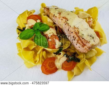Italian Pappadelle Pasta With A Roasted Salmon Steak And Vegetables