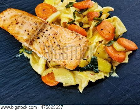 Italian Pappadelle Pasta With A Roasted Salmon Steak And Vegetables