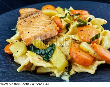 Italian Pappadelle Pasta With A Roasted Salmon Steak And Vegetables