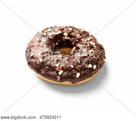 One Donut In Chocolate Glaze Sprinkled With Pieces Of White, Milk And Dark Chocolate Isolated On A W