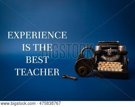 Vintage Typewritter And Padlock With The Word Experience Is The Best Teacher On Blue Background
