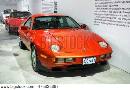 Toronto, Canada - 02 25 2023: Orange Metallic Porsche 928 Two-door High Performance Grand Touring Sp