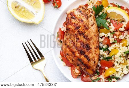 Grilled Chicken Fillet With Bulgur Tabbouleh Salad With Colorful Tomatoes, Parsley And Lemon Dressin