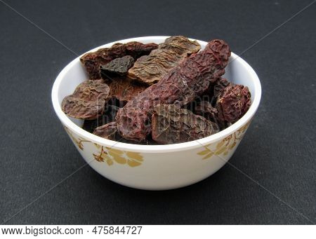 Dried Shikakai Or Acacia Concinna In A Bowl On Black Background