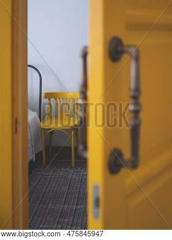 Edge Of The Bed And A Next Standing Chair From Half-open Door, Selective Focus. Concept Of Care Of B