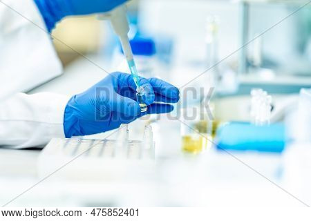 Pipetting Of Chemical Samples During Research In A Biochemical Scientific Laboratory