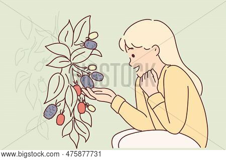 Girl Sits Near Bush With Fresh Raspberries Or Blackberries Tasting Fruits Of Fruit Plant Walking Thr