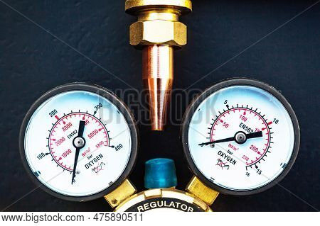 The Upper Part Of The Torch With A Copper Tip And The Pressure Regulator Of The Oxygen Cylinder With